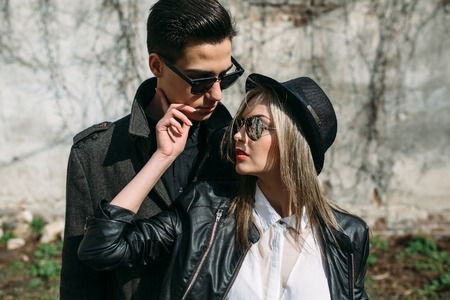 Photo of a young beautiful couple on the background of the old wallの写真素材