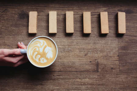 Photo of art composition - latte in hand