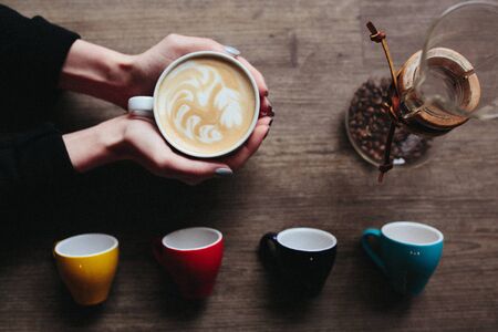 Photo of art composition - latte in handの写真素材