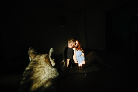 manly husband tenderly embracing his pregnant wifeの写真素材