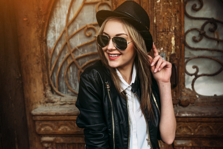 Young beautiful girl posing on a background of an old buildingの写真素材