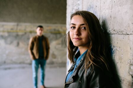 handsome guy and beautiful girl posing in a bystreetの写真素材