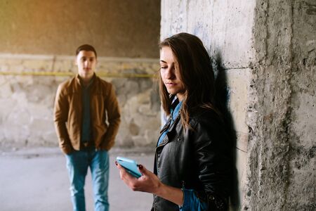 handsome guy and beautiful girl posing in a bystreetの写真素材