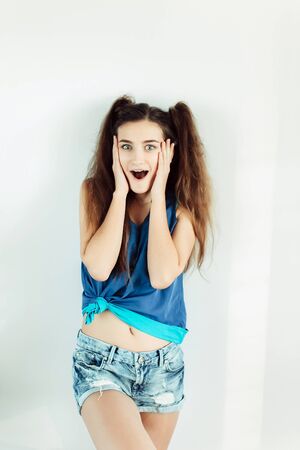 young beautiful girl posing on a white backgroundの写真素材