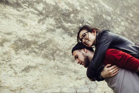 man carries his girlfriend on his backの写真素材