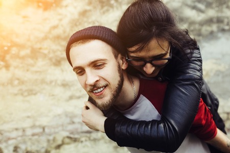 man carries his girlfriend on his backの写真素材