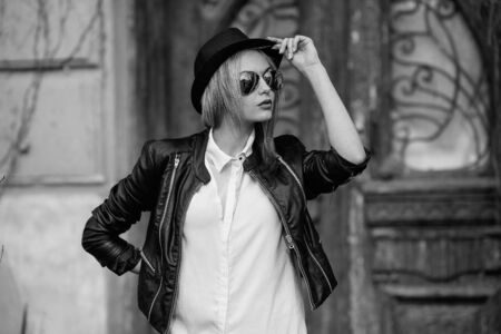 Young beautiful girl posing on a background of an old building
