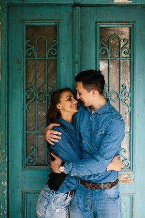 young beautiful couple posing on the background of an old buildingの写真素材