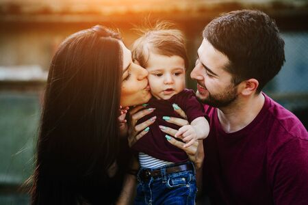 Young family with child posing on the background of an abandoned buildingの写真素材