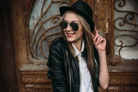 Young beautiful girl posing on a background of an old building