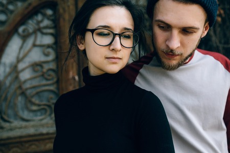 young beautiful couple posing on the background of an old buildingの写真素材