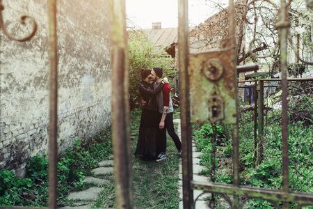 young beautiful couple posing on the background of an old buildingの写真素材