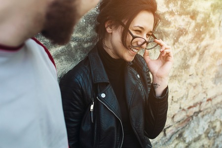 young beautiful couple fooling around on the background wallの写真素材