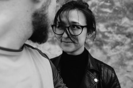 young beautiful couple fooling around on the background wallの写真素材