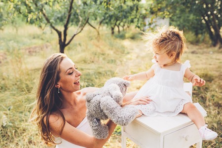 mother and daughter together in garden outdoorsの写真素材