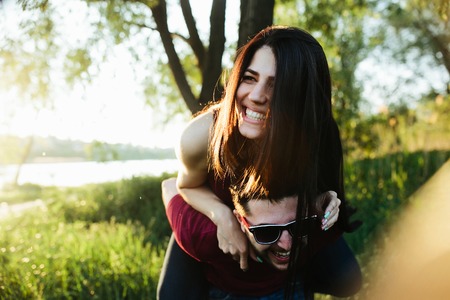Young beautiful couple having fun in the nature of the countrysideの写真素材