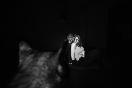 manly husband tenderly embracing his pregnant wifeの写真素材