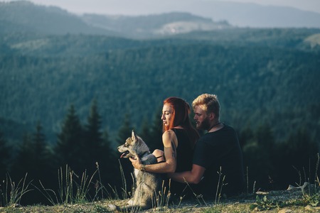 beautiful couple standing on a hill and looks into the distance