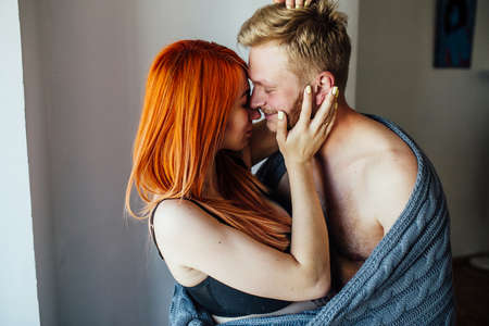 young beautiful couple posing for the camera indoorsの写真素材