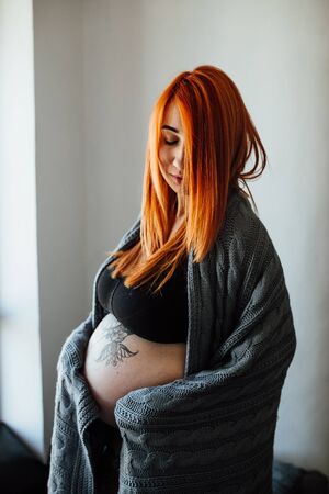 young pregnant woman posing for the cameraの写真素材