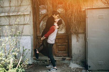 young beautiful couple posing on the background of an old buildingの写真素材