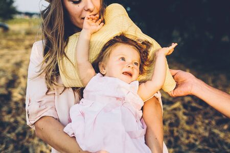 Happy mother and daughter laughing together outdoorsの写真素材