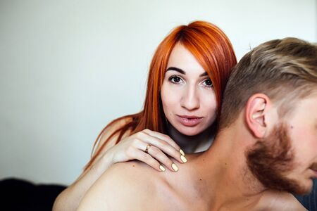 young beautiful couple posing for the camera indoors