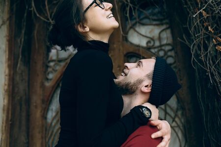 young beautiful couple posing on the background of an old buildingの写真素材