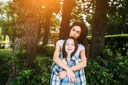 Mother and daughter spend a fun time in the park parkの写真素材