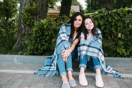 Mother and daughter spend a fun time in the park parkの写真素材