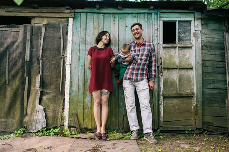 Young family with child posing on the background of an abandoned buildingの写真素材