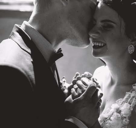 Bride and groom posing in a room with a close angleの写真素材
