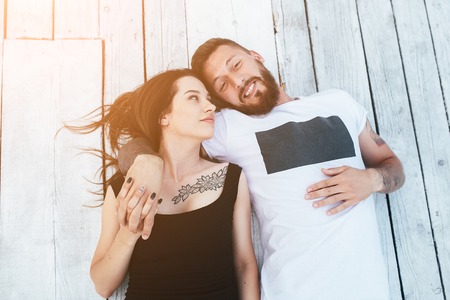 man and woman lying together on the wooden floor