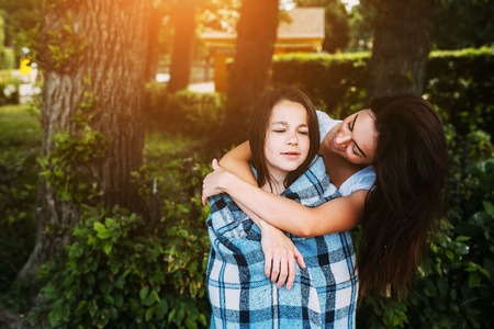 Mother and daughter spend a fun time in the park parkの写真素材