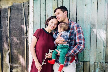 Young family with child posing on the background of an abandoned buildingの写真素材