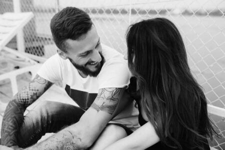 beautiful couple posing on a wooden pier at lakeの写真素材