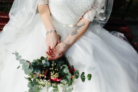Bride holding wedding bouquet in her hands, close viewの写真素材