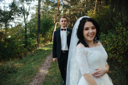 Beautiful wedding couple posing in a forestの写真素材
