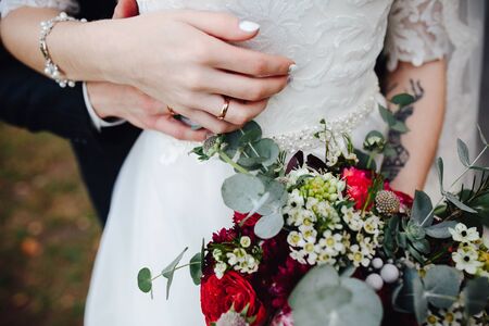 Bride holding wedding bouquet in her hands, close viewの写真素材