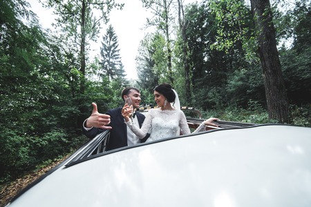 the bride and groom traveling in the carの写真素材