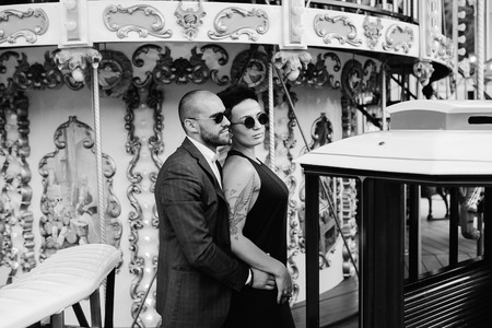 adult man and woman on merry go round carouselの写真素材