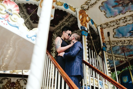 adult man and woman on merry go round carouselの写真素材