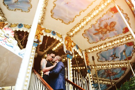 adult man and woman on merry go round carouselの写真素材