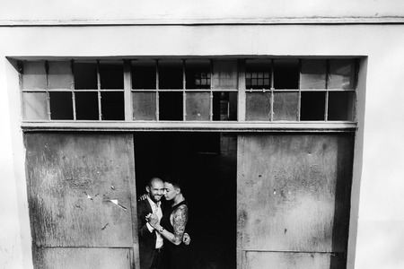 man and woman hugging in the doorway of an abandoned buildingの写真素材