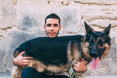 man holding his dog in his armsの写真素材