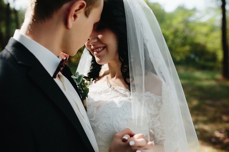 Beautiful wedding couple posing in a forestの写真素材