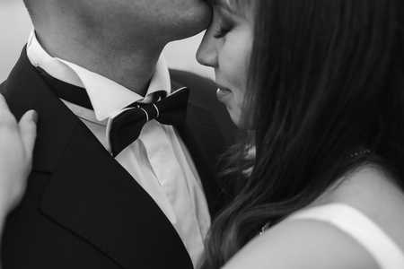 Bridal couple close to each other, posing in parkの写真素材