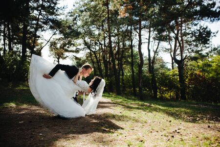 Beautiful wedding couple posing in a forestの写真素材