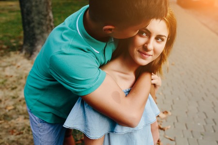 guy and girl in a park posing on camera, close view