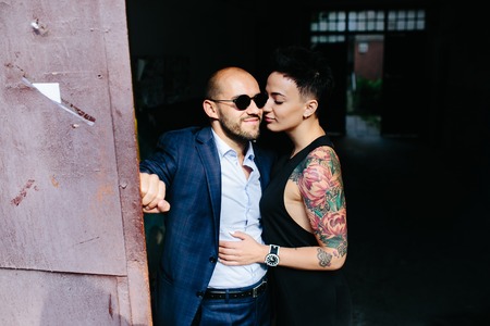 man and woman hugging in the doorway of an abandoned buildingの写真素材